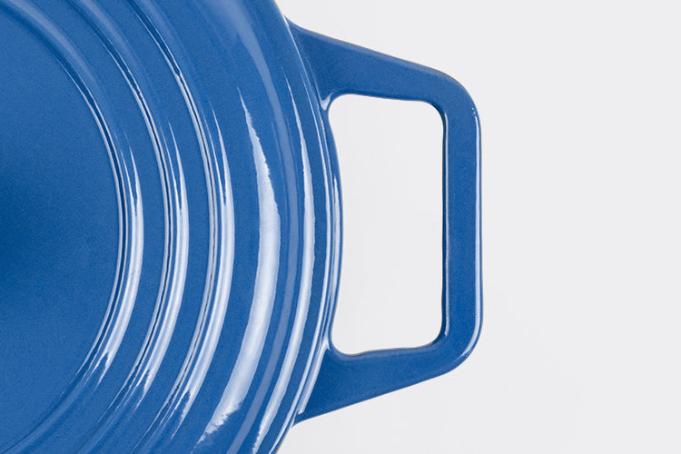 Right side of blue Misen Dutch Oven with Grill Lid seen from above on a white background.