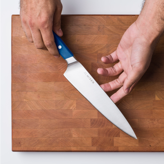 Showcasing the spine and belly of the Misen Chef Knife
