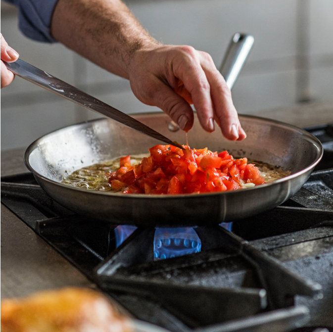 Sauteéing tomatoes and onions in a Misen Stainless Steel Skillet