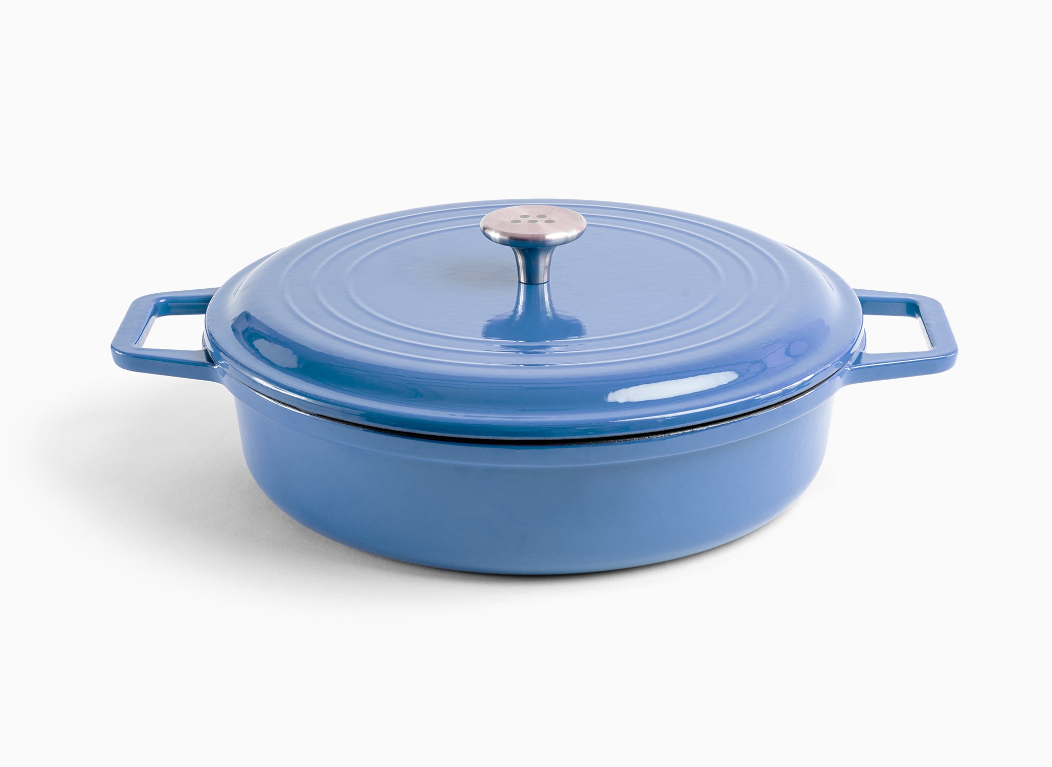 A blue Misen Enameled Cast Iron Braiser with knob-handle lid. Misen logo is visible on the lid’s central handle.