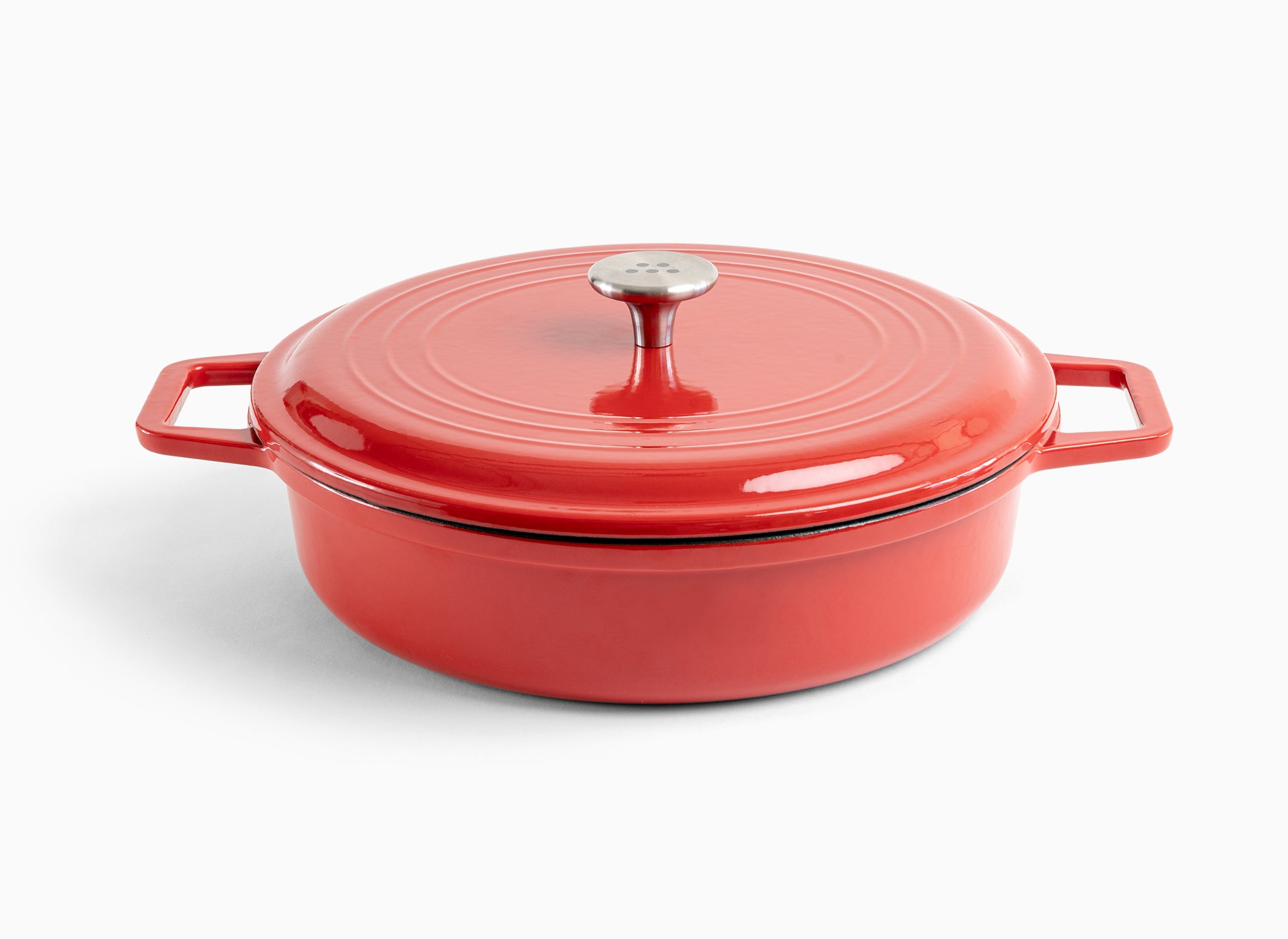 A red Misen Enameled Cast Iron Braiser with knob-handle lid. Misen logo is visible on the lid’s central handle.